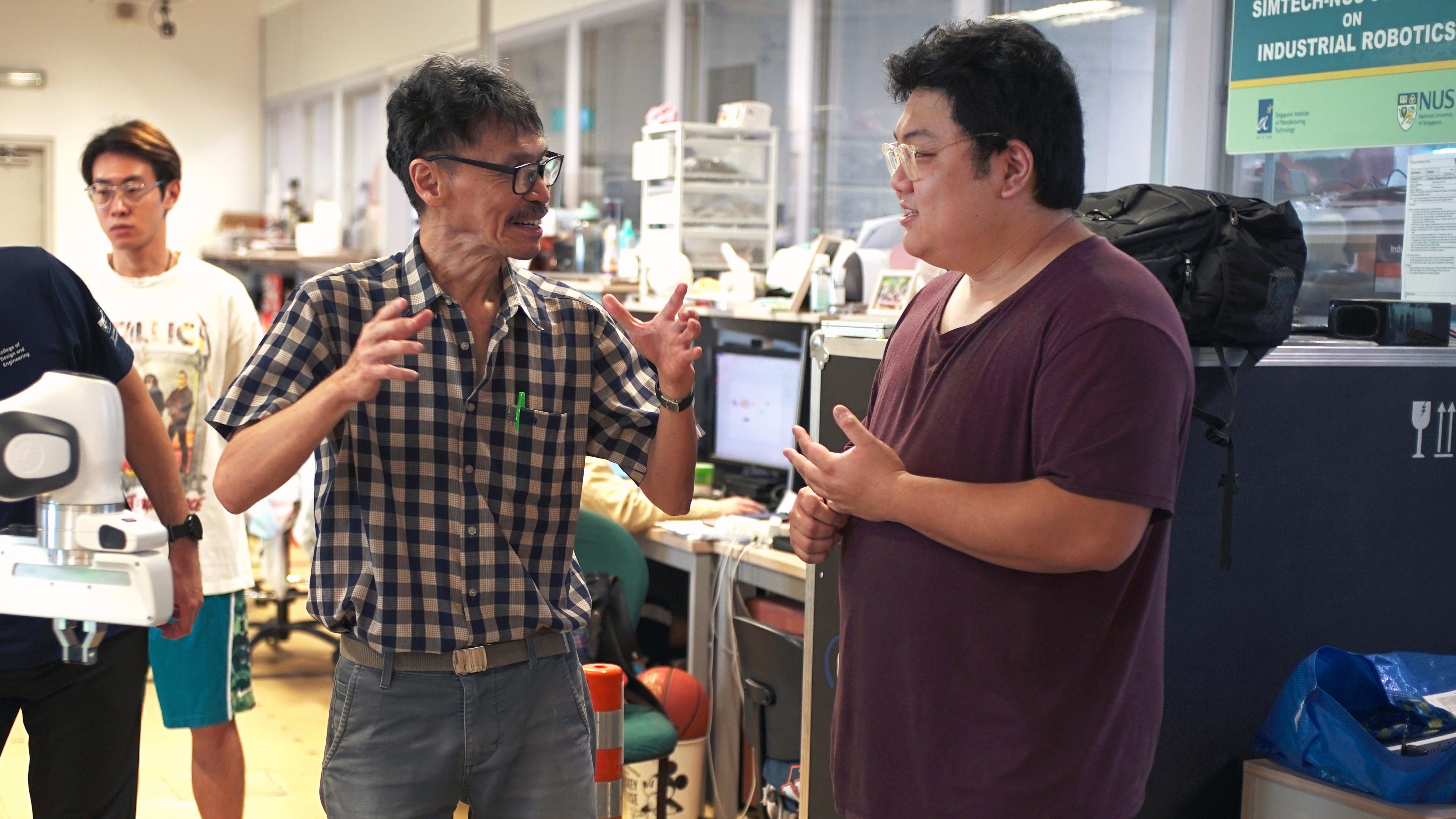Prof Marcelo Ang with Ziggy at the Advanced Robotics Centre (ARC).