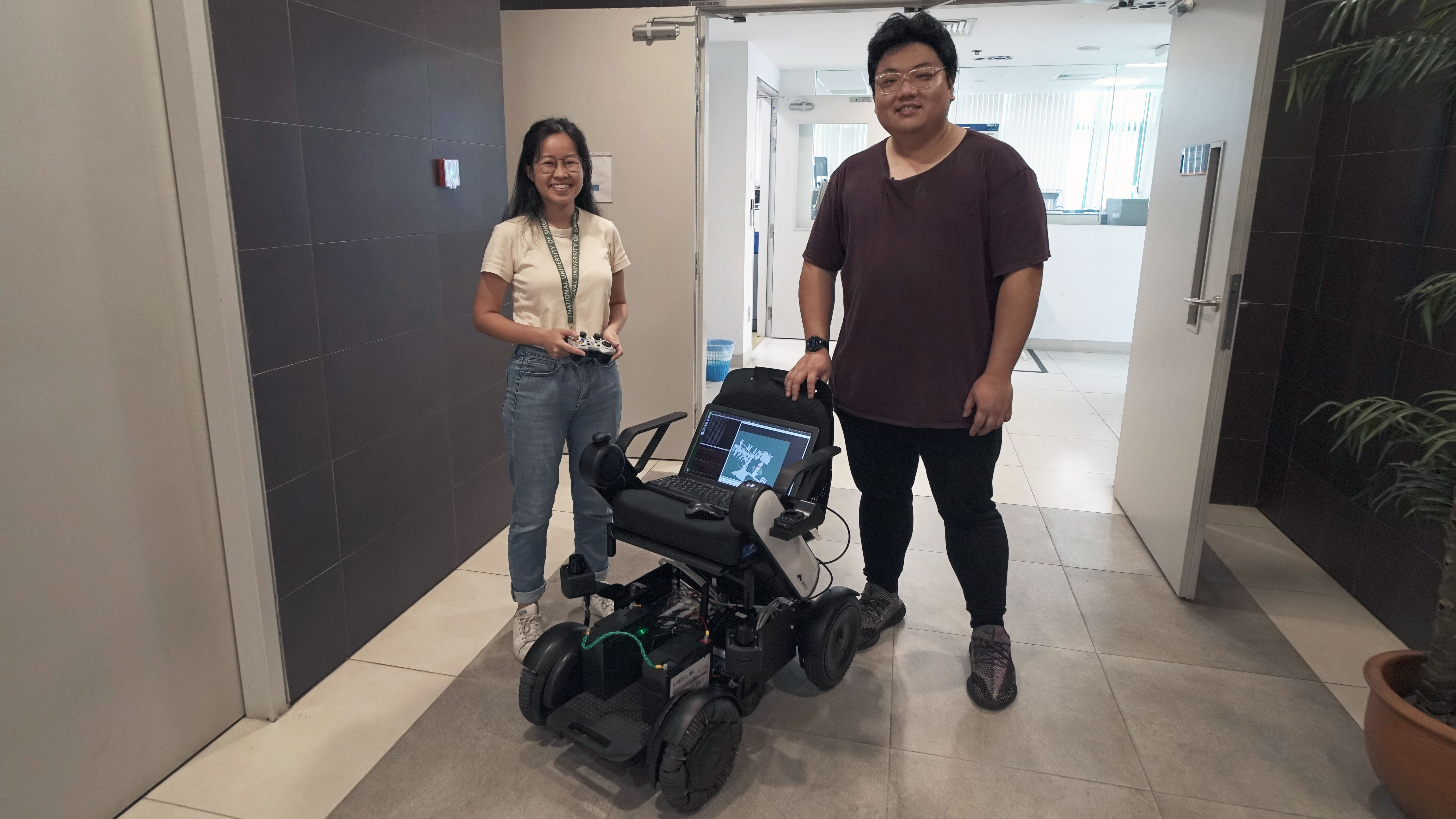 (Left) Ziggy and his teammate Christina Lee with the autonomous wheelchair they’ve both been working on. 